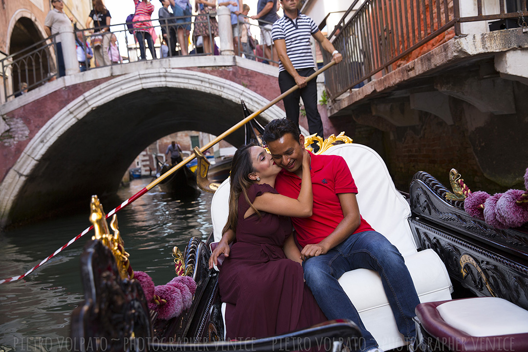 Venice photographer for a vacation photo shoot and tour. Romantic and fun photos of a couple in Venice during a photo walk and gondola ride.