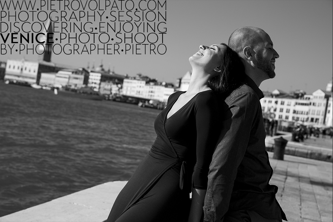 A couple enjoying a romantic moment during an engagement photography session, with the Piazza San Marco far away in the background.