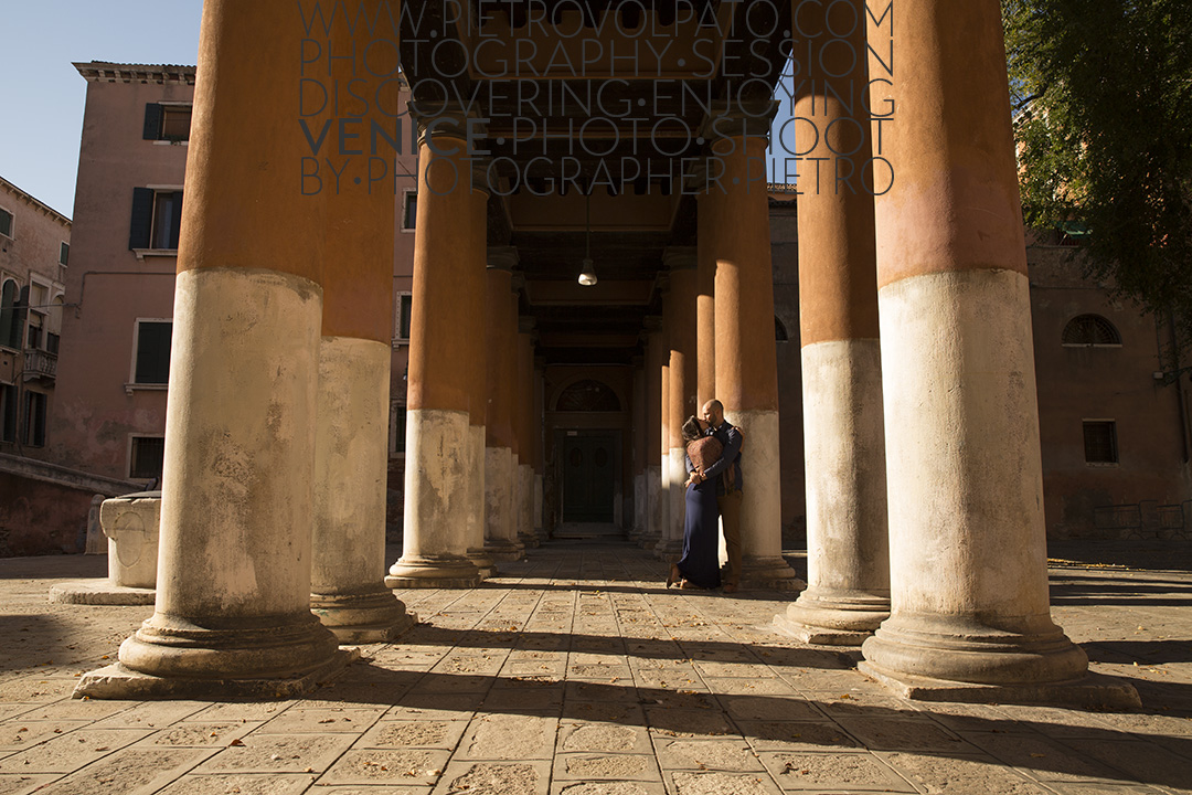 A couple kissing during an engagement photography session, in San Francesco Della Vigna in Venice.