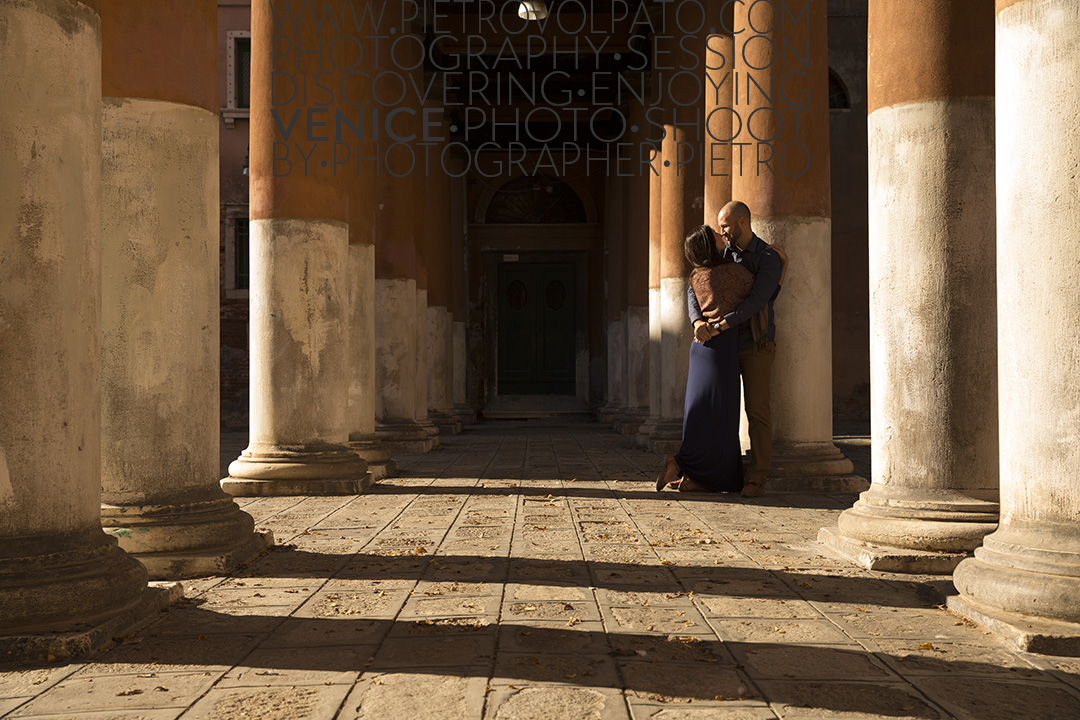 A couple enjoying a romantic moment during an engagement photography session, in San Francesco Della Vigna in Venice.