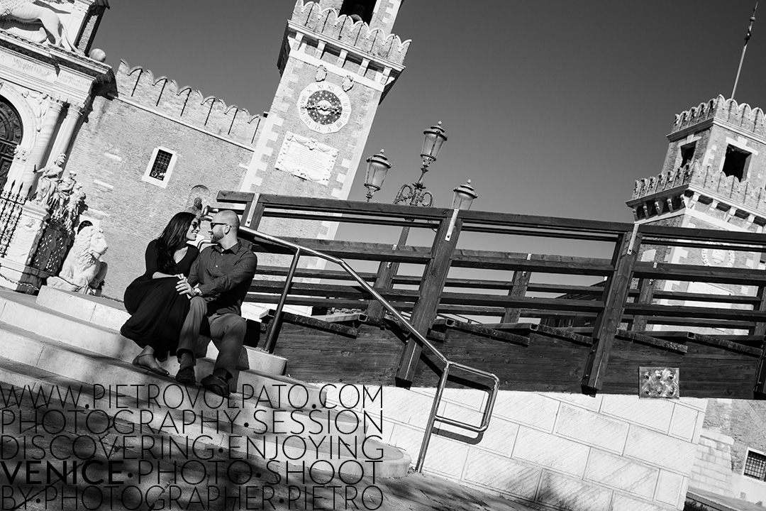 A couple enjoying a romantic moment during an engagement photography session, just outside the Arsenale in Venice.