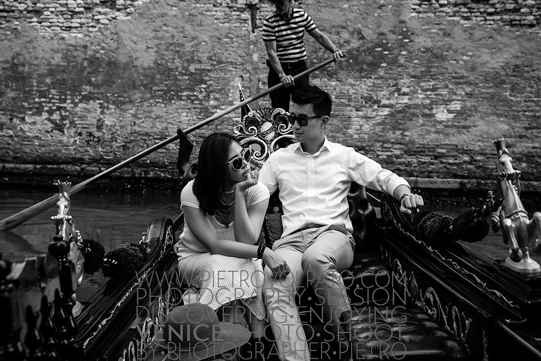 A couple enjoying a gondola ride in Venice. This photo is part of a Venice portrait photo shoot by local photographer Pietro Volpato.