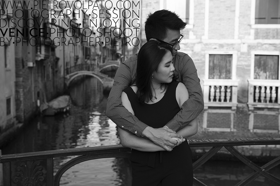 A couple having a romantic moment on a bridge in Venice with iconic canals in the background during the sunset.