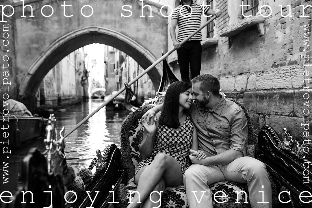 A couple enjoys a romantic moment on a gondola along a quiet canal in Venice. This photo was taken during an original photoshoot and tour by local photographer Pietro Volpato.