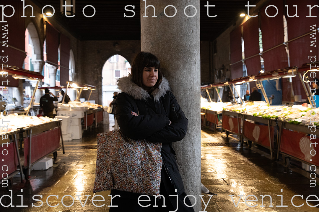 A woman enjoys a moment at the famous Rialto Fish Market in Venice. This photo is part of a photoshoot in Venice by photographer Pietro Volpato.